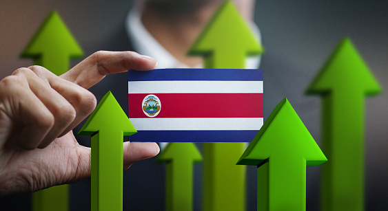 Nation Growth Concept, Green Up Arrows - Businessman Holding Card of Costa Rica Flag