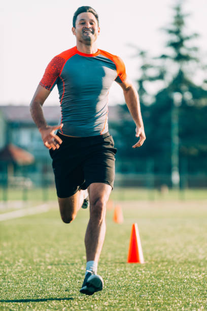 istock Full Length Of Man Running On Grassy Field 1077462936