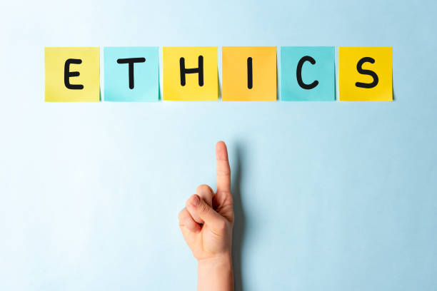 Hand pointing ethics word in multicolored notes on blue background Hand pointing ethics word in multicolored notes on blue background code of ethics stock pictures, royalty-free photos & images