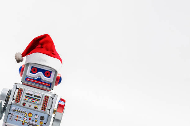 Vintage robot retro classic toy with Christmas hat on white background . stock photo