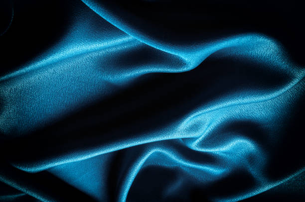 istock Texture, background. template. Silk fabric blue, Blue silk drapery and upholstery fabric from the courtyard - Dark curtains - Solid fabrics for backs and pillows 1077470370