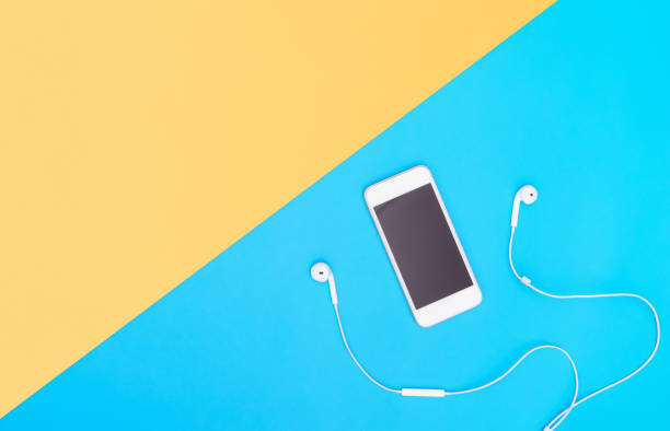 istock Empty Mobile phone screen with Music earphone on blue copy space for poster and text 1077470424