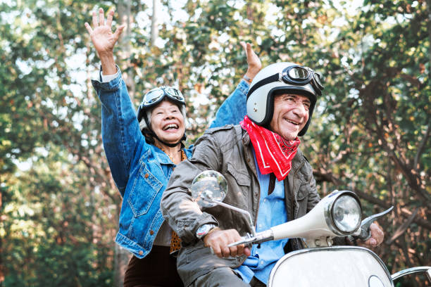 istock Senior couple riding a classic scooter 1077472520