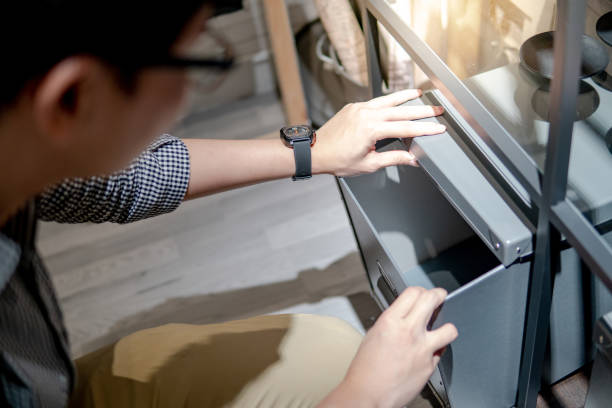 istock Asian man opening grey box on shelf. Home decoration concept 1077472784