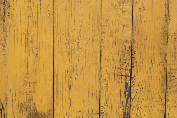istock obsolete yellow painted wooden background texture 1077477110