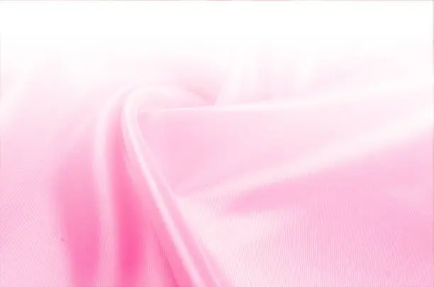 Photo of Texture, background, pattern. Light beige, pink shades of silk fabric, text space. Pink silk background based on natural texture