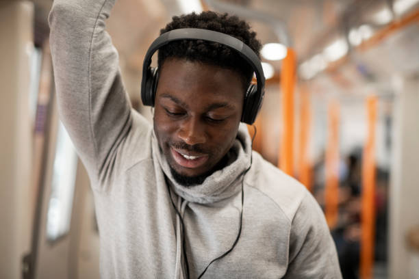 istock Happy man riding the underground train 1077479372