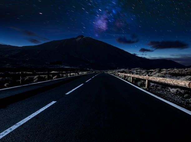 istock Night mountain road .Night sky with milky way and stars. 1077479432