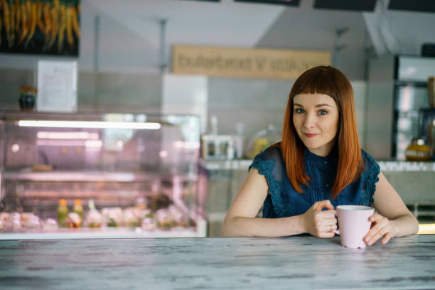 istock Pretty woman sitting in a cafe 1077479538