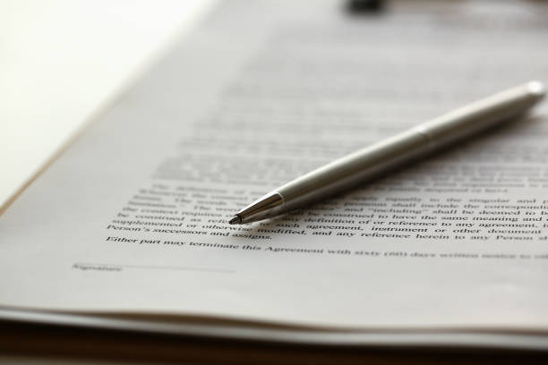 istock Silver pen lying on form clipped to pad 1077482166