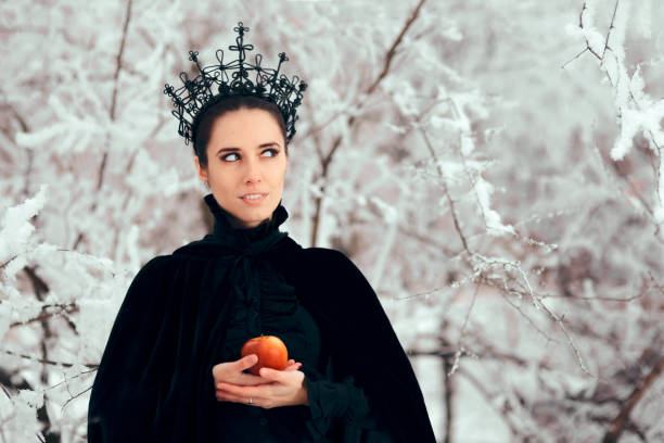 istock Evil Queen with Poisoned Apple in Winter Wonderland 1077492070