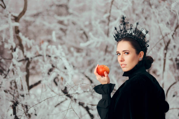 istock Evil Queen with Poisoned Apple in Winter Wonderland 1077492078