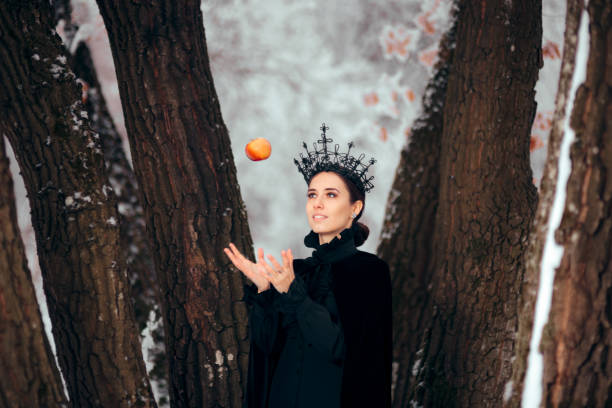 istock Evil Queen with Poisoned Apple in Winter Wonderland 1077492096