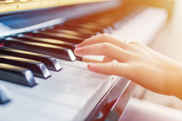 istock Hand of a Kid Playing Piano 1077503020