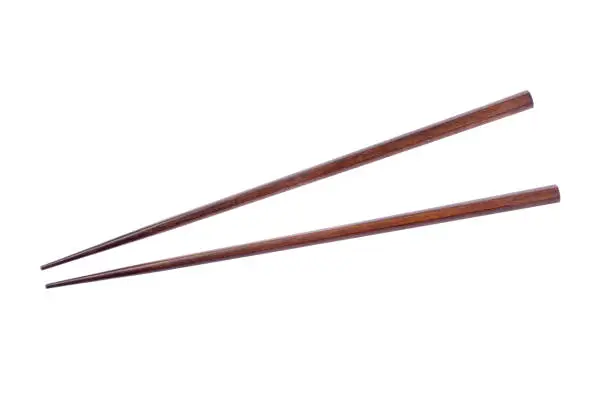 Photo of Wooden chopsticks on white background.