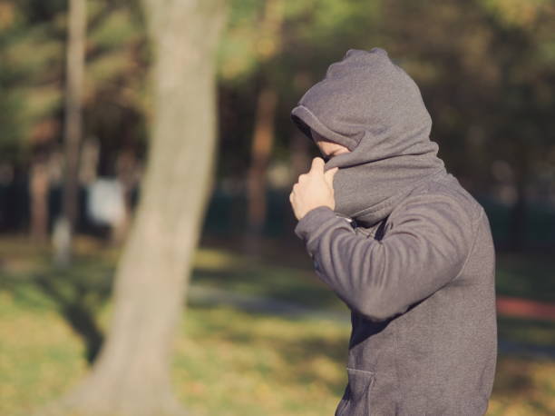 Man Hiding Face with Hood