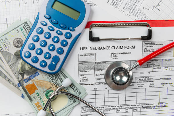 istock Health insurance application form with banknote and stethoscope concept 1077512630