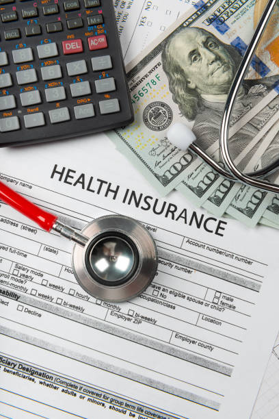 istock Health insurance application form with banknote and stethoscope concept 1077512638