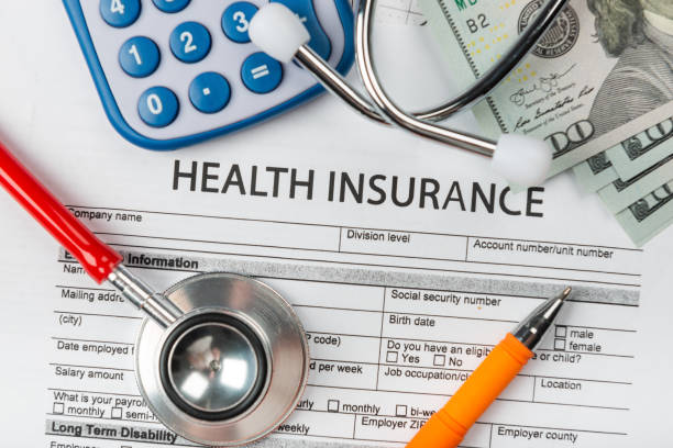 istock Health insurance application form with banknote and stethoscope concept 1077512678