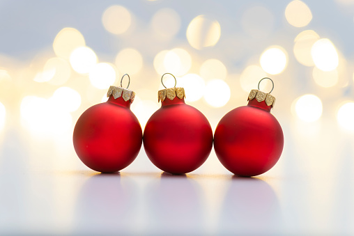 Red christmas baubles on shiny background.