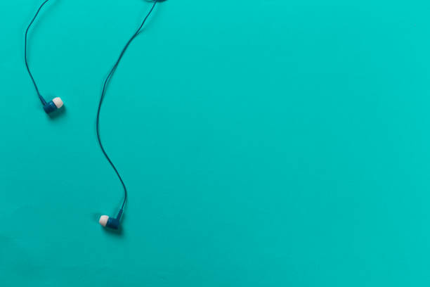 istock black earphones on blue background 1077518070
