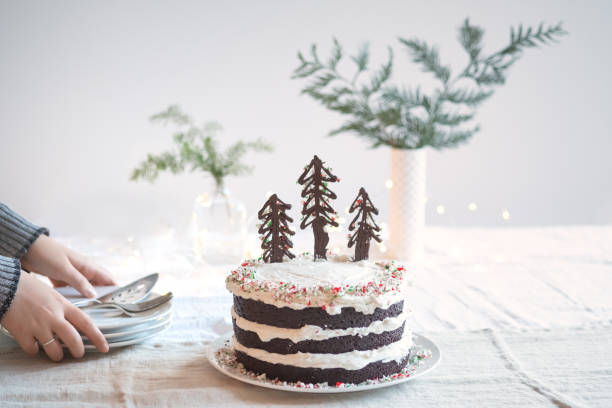 Woman Setting Down Plates for Vegan Christmas Tree Cake
