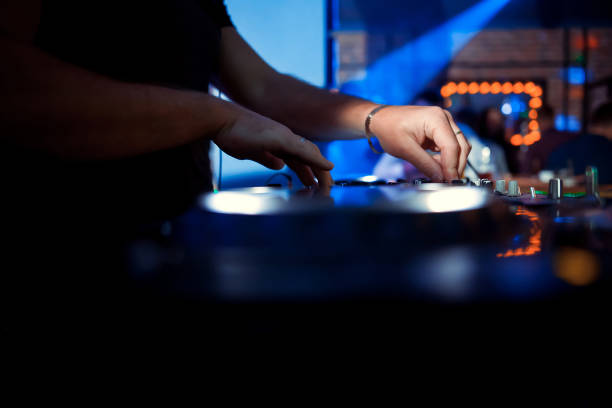 istock DJ playing music at mixer closeup 1077522800