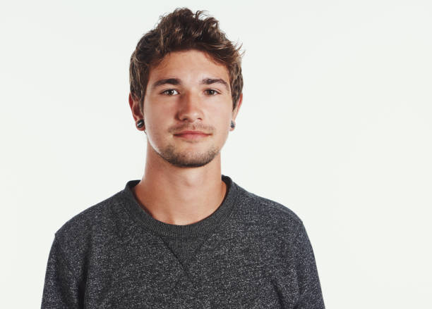 istock Good-looking young man with goatee beard looks serious 1077523422