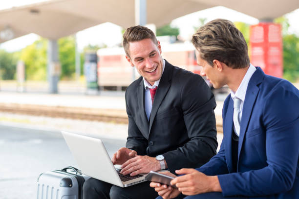 istock Two young businessmen at train station 1077523636