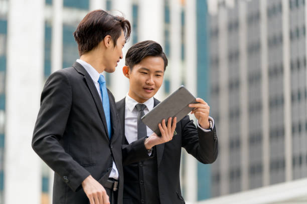 istock Two young businessmen having a meeting on the go 1077524070
