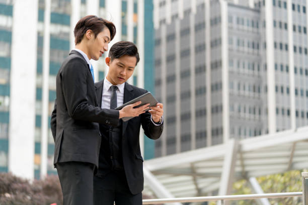 istock Two young businessmen having a meeting on the go 1077524084