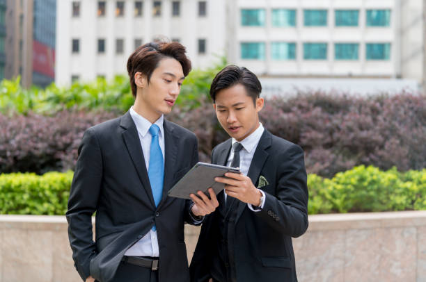istock Two young businessmen having a meeting on the go 1077524094