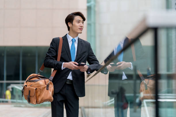 istock Young businessman using his phone outdoors 1077524150