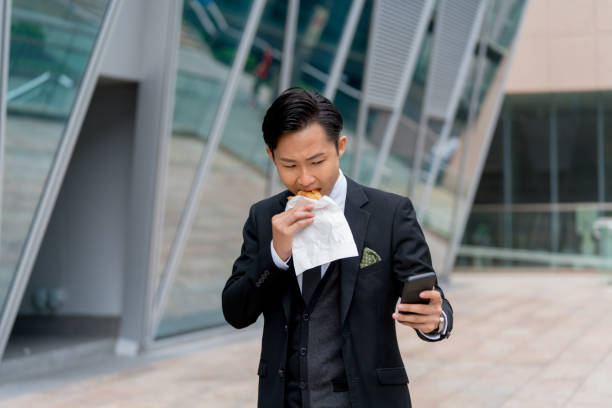 istock Young businessman using his phone on his lunch break 1077524222