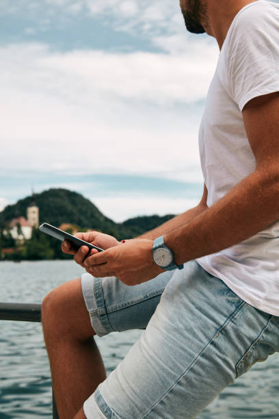 istock Modern guy using cellphone in the European city. 1077528804