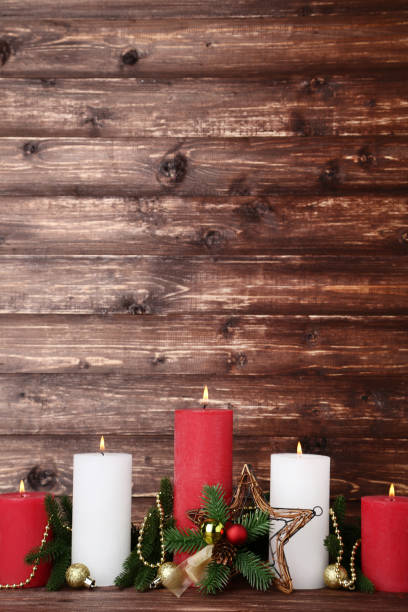 istock Christmas candles with fir tree branches and baubles on brown background 1077529200