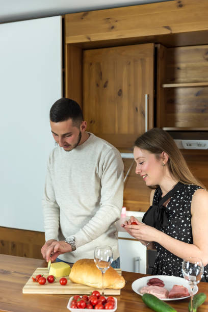 istock Handsome Young Man and His Beautiful Girlfriend Enjoying in the Kitchen 1077532160