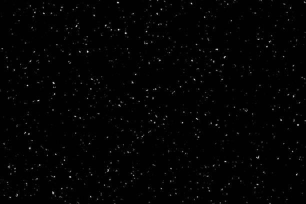 Falling snow on black background. Winter background in pure dark. Heavy snow.