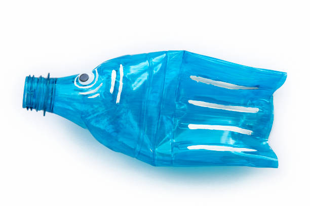 istock Plastic bottle recycled in a fish figure. Reuse garbage 1077536654