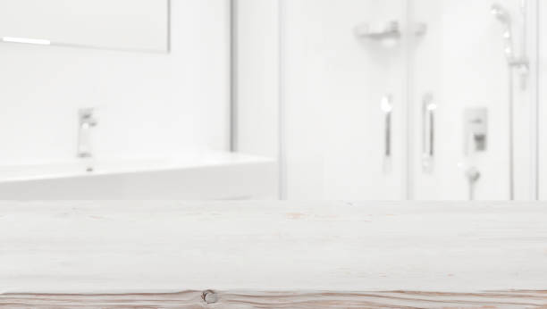 istock Wooden table top and blurred white bathroom interior as background 1077537858