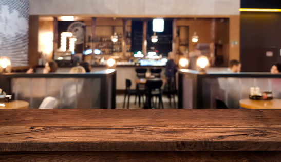Table top counter with blurred people and restaurant interior background
