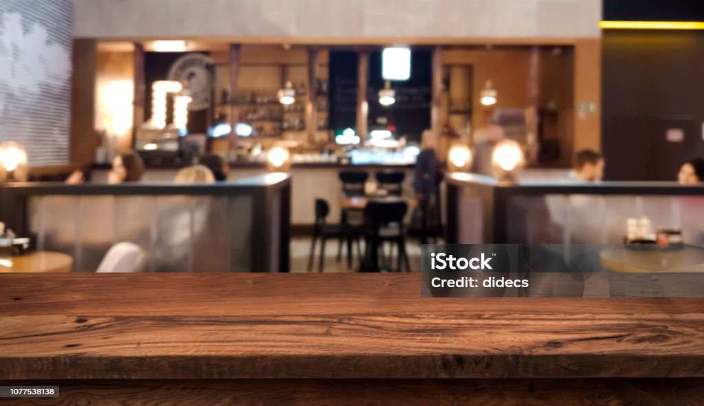 Table top counter with blurred people and restaurant interior background Table Stock Photo