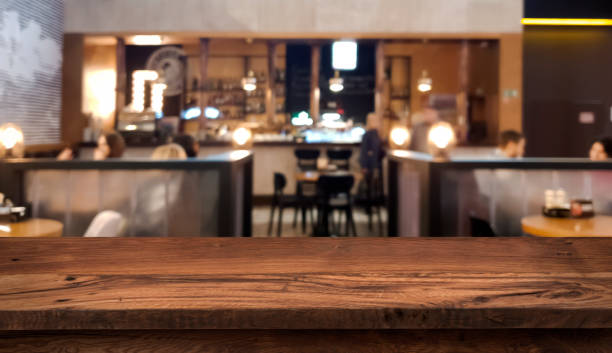 table top counter with blurred people and restaurant interior background - balcão imagens e fotografias de stock