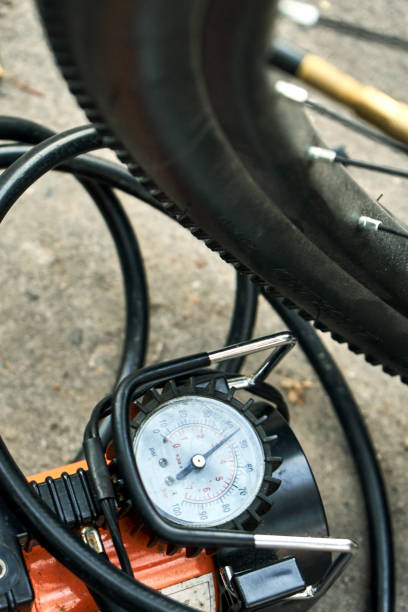 istock Pumping up a bicycle tire using an electric air car compressor 1077538660