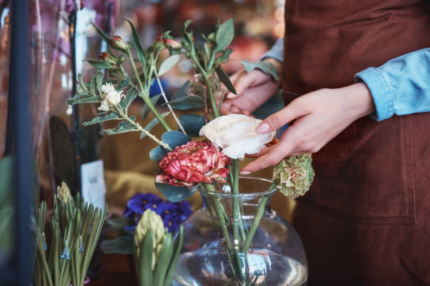 istock Young florist with flowers 1077542738