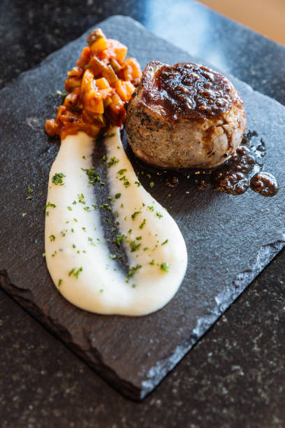 istock Fine dining: Mini beef steak with meat sauce served with mash potato and salad. 1077545006