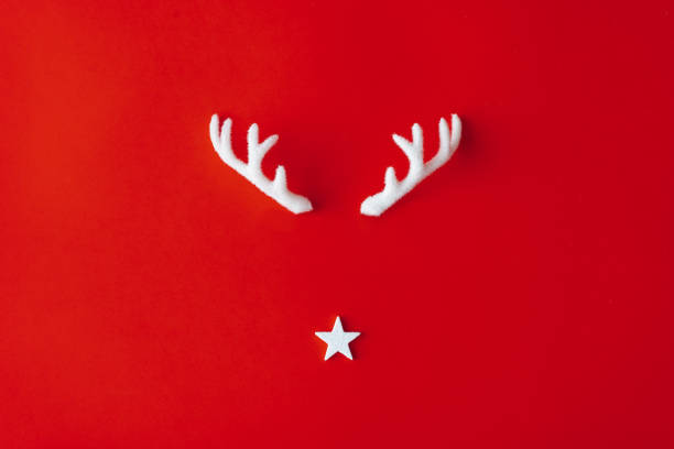 Reindeer antlers with star on red background.