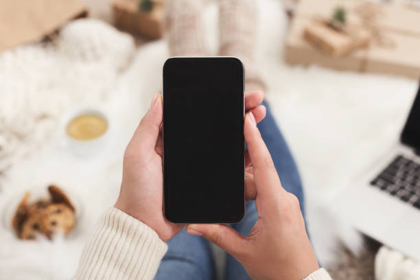 istock Christmas online shopping background. Smartphone screen with copy space 1077547446
