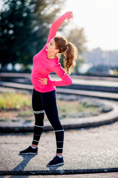 istock Young  woman stretching after training 1077551718