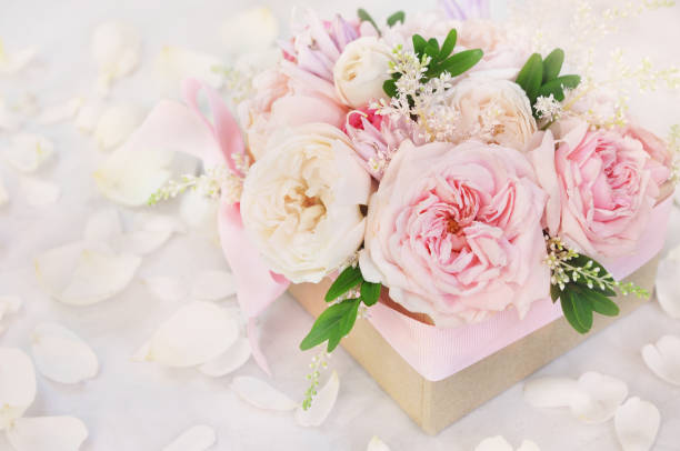 istock Present box with summer blossoming delicate roses and pink flowers 1077551826